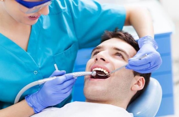 dentist_cleaning_mans_teeth